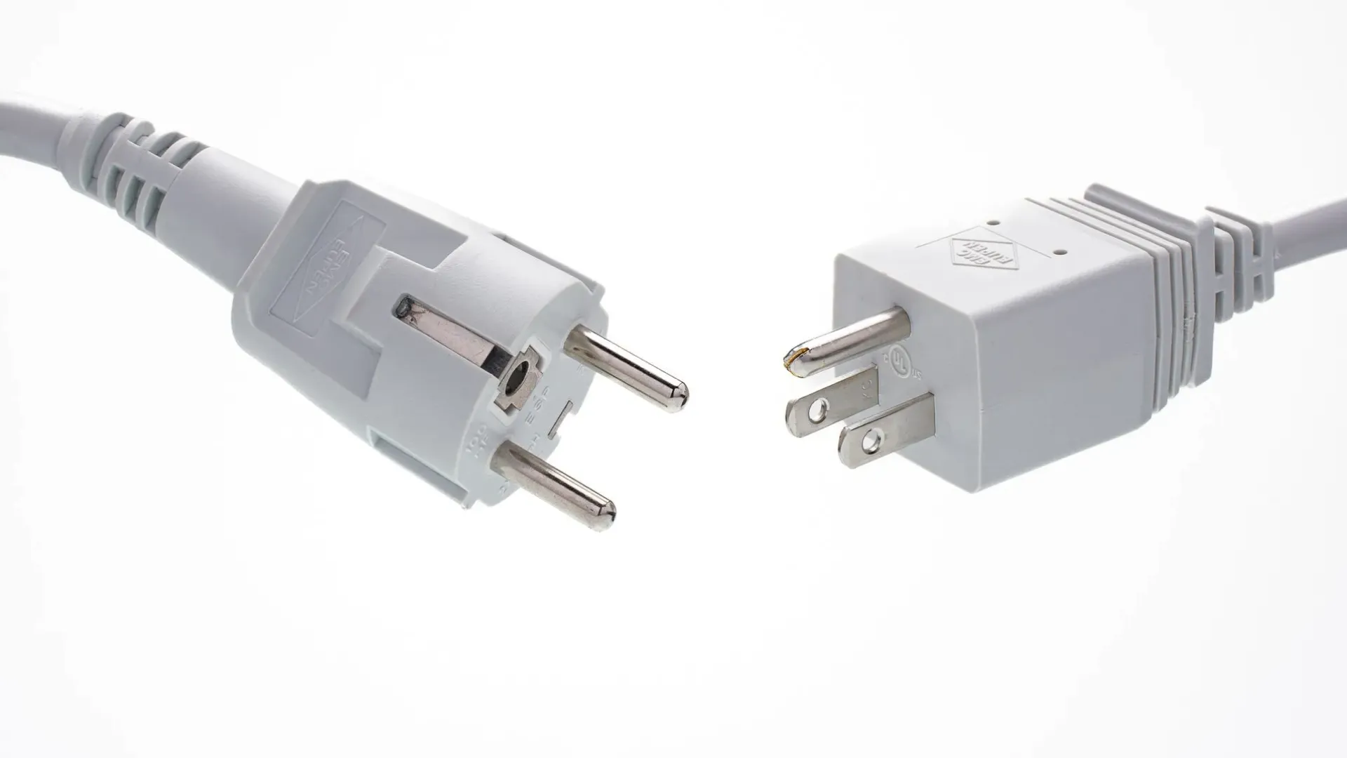 Two different types of electrical plug adapters on a white background.